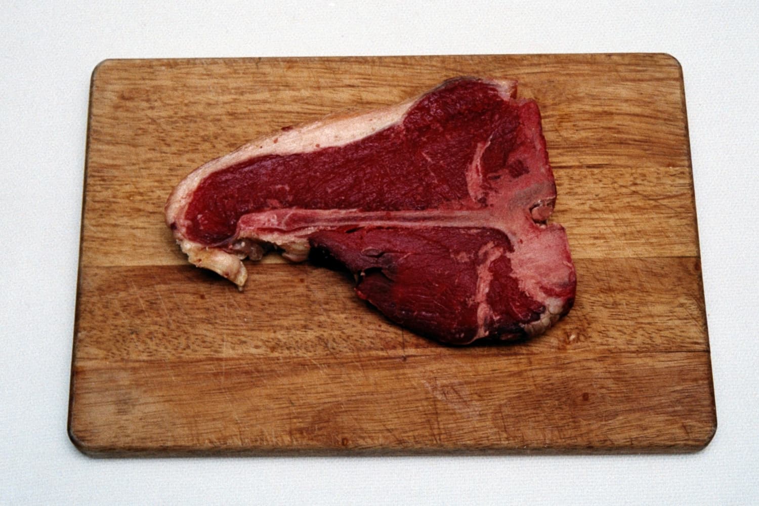 Garlic and Pepper T-bone Steak on chopping board