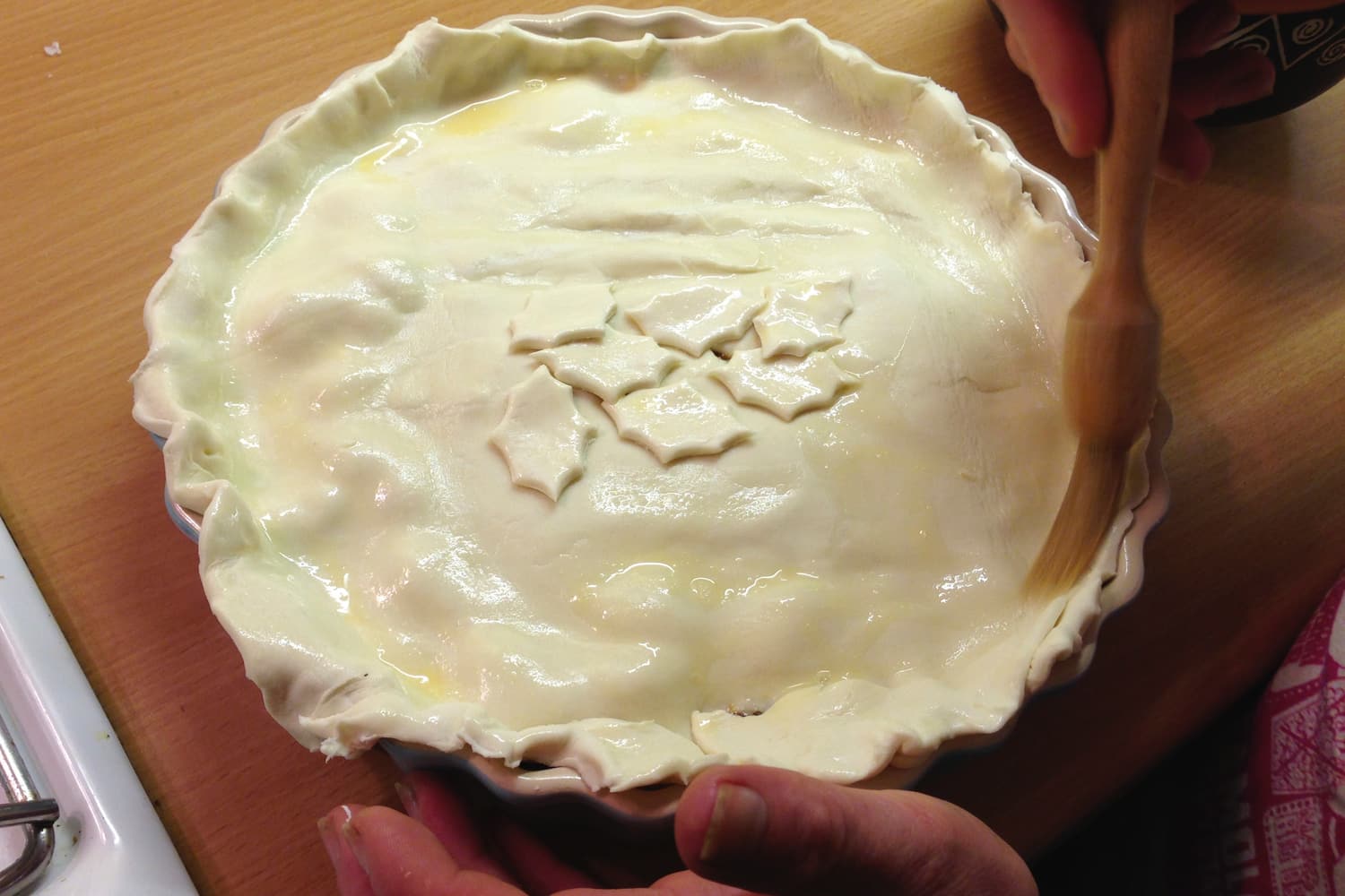 Brushing the pastry with egg wash