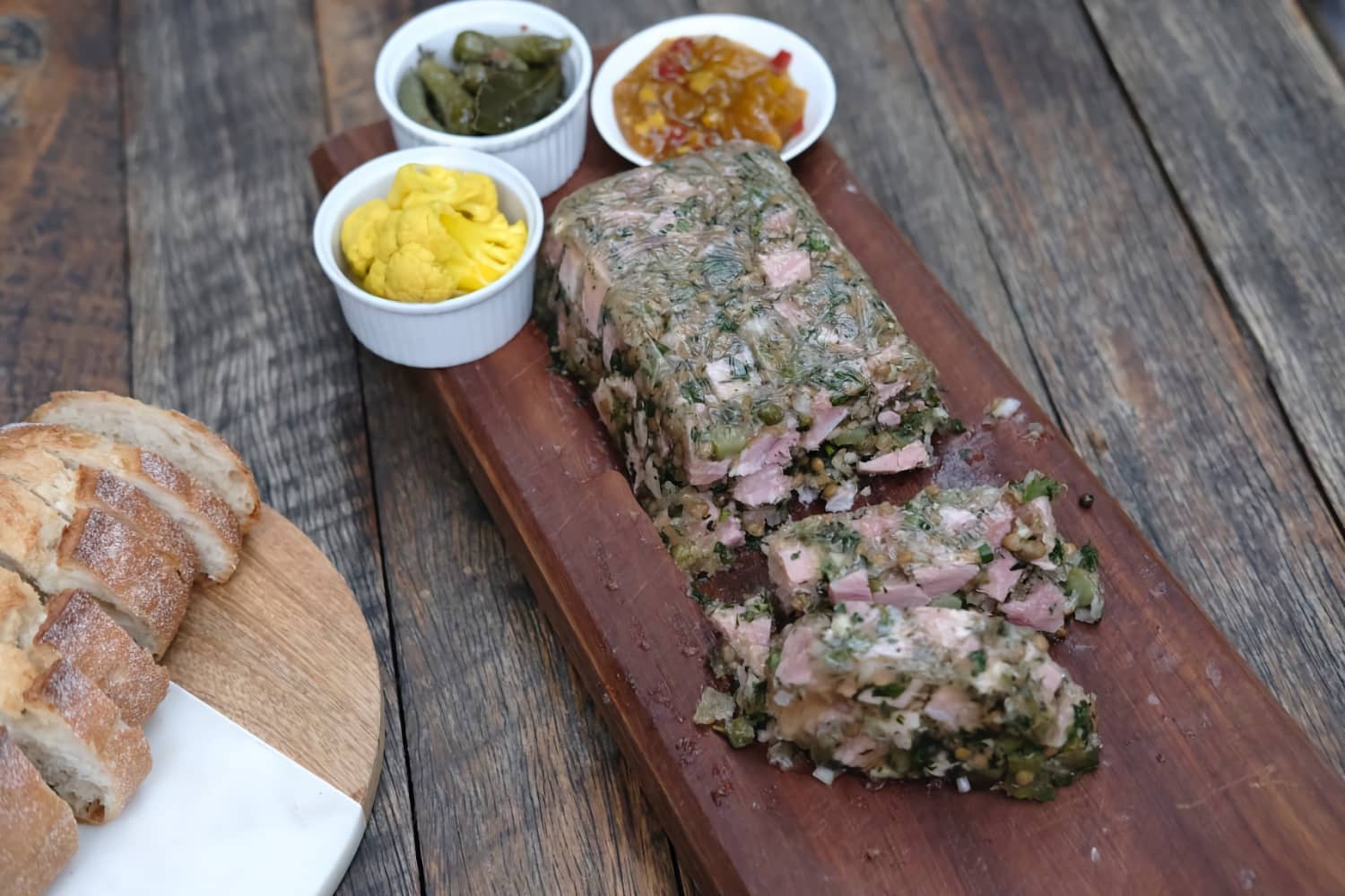 Ham Terrine with condiments and bread.