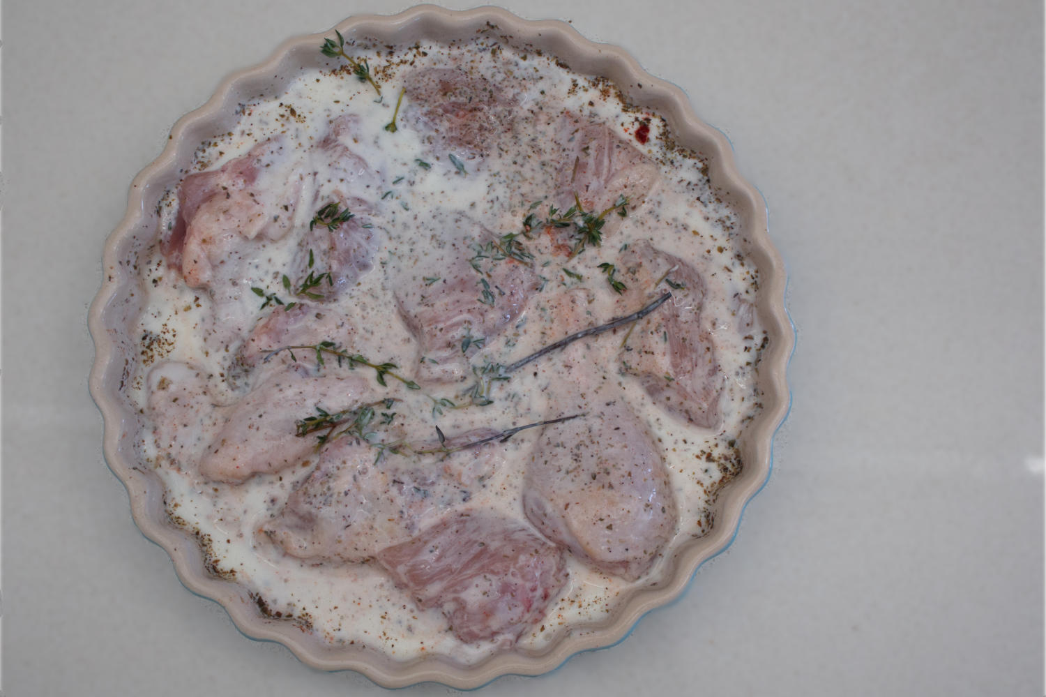 Chicken marinating before crumbing.